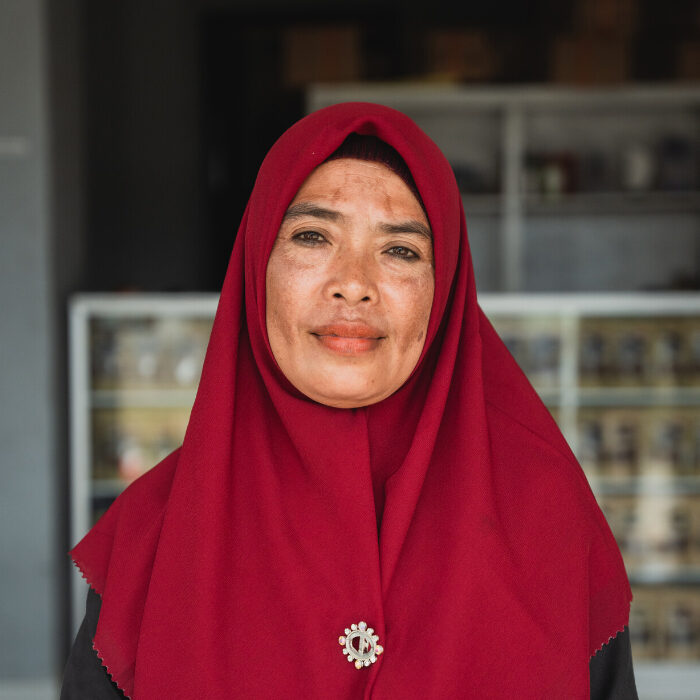 Portrait of Syaeun. She is wearing a red headscarf in Sembalun, East Lombok district, Indonesia.