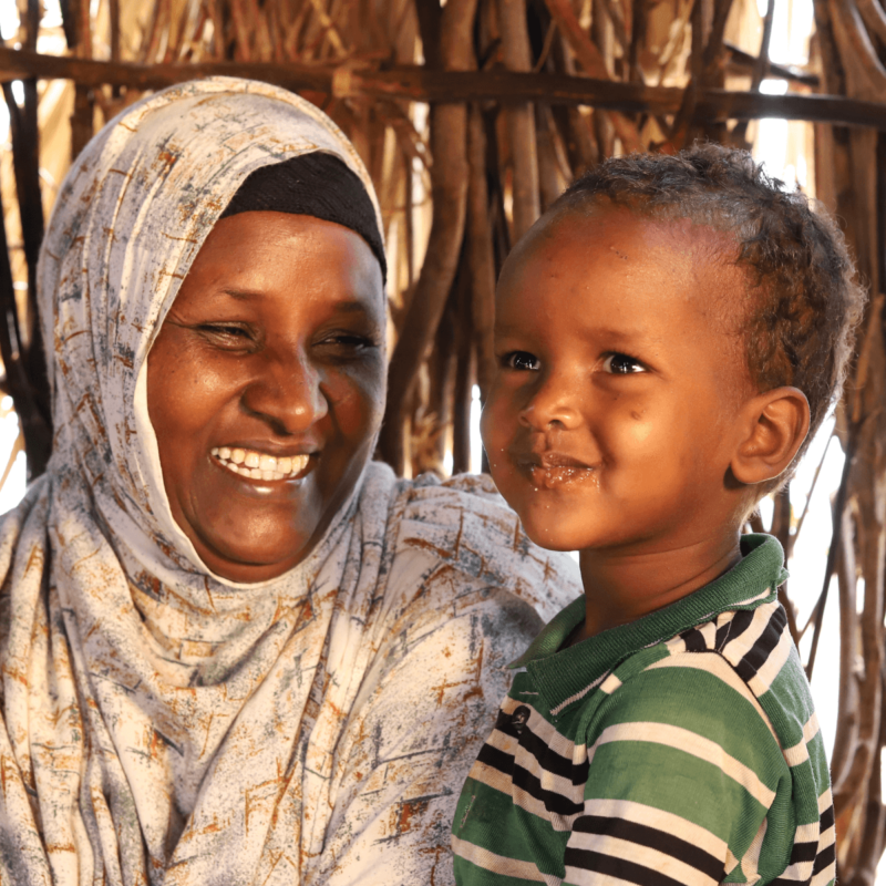 Isiolo county, Kenya: Abdia, pictured with her son, took part in a water project in Barambale, Isiolo county, where a water point was set up by Oxfam and our local partner organisation, Merti Integrated Development Program. Photo: Eyeris Communications/Oxfam.