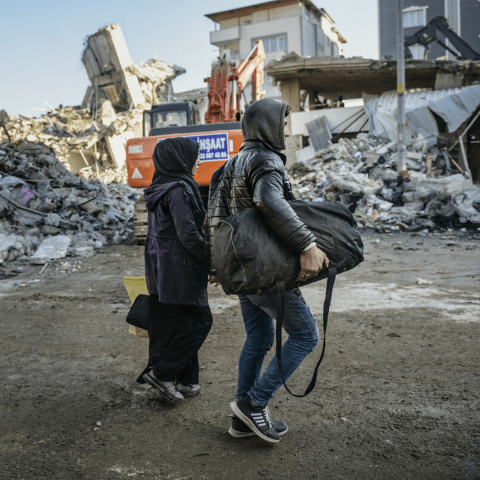 Islahiye, Türkiye: Two local residents gather belongings from their destroyed home, before joining the thousands of displaced survivors of the disaster. Photo: Tineke D'haese/Oxfam.