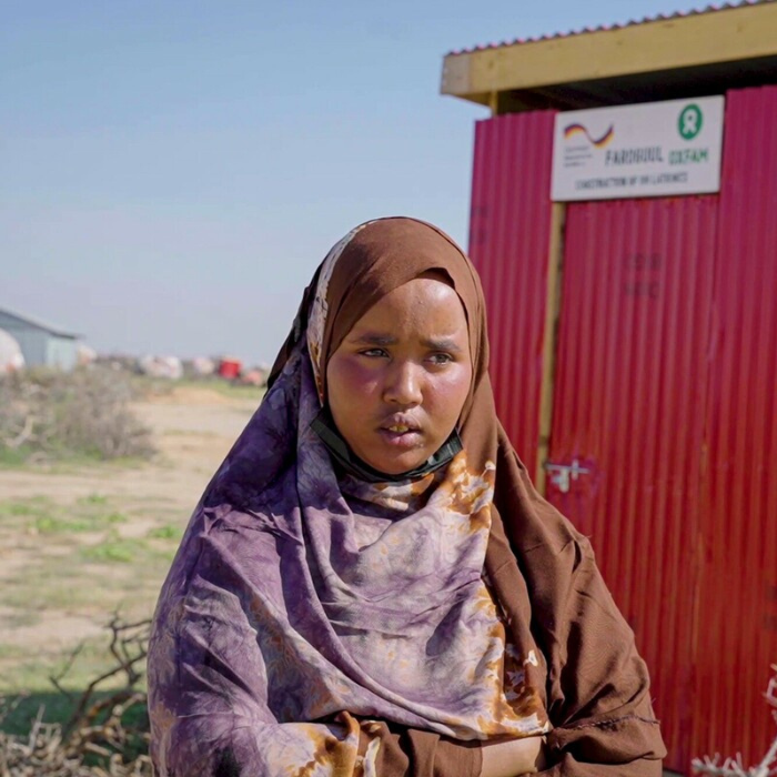 Sanag Region, Somalia: Kowsar Hussien, one of the GFFO project participants standing next to an Oxfam built latrine in Sanaag Region of Somaliland. Photo: Ahmed Osman/Oxfam